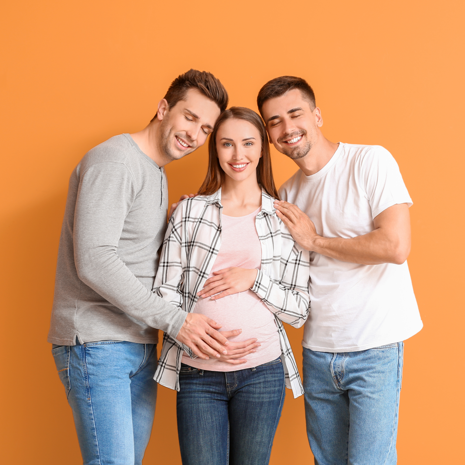 A surrogacy team pictured with a surrogate in the middle and her two same sex intended parents either side